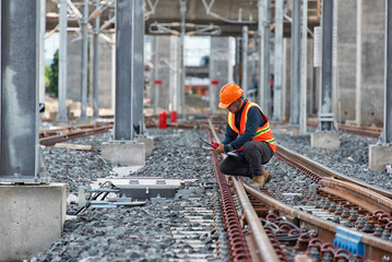 Engineer Inspecting Railway Track During Construction