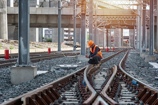 Engineer Inspecting Railway Track During Construction