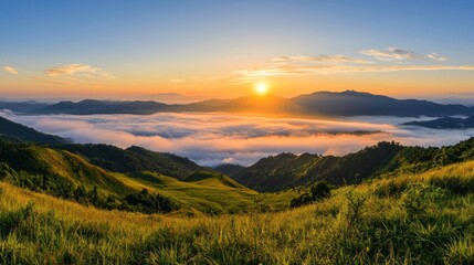 Obraz premium Majestic landscape showing mountains at a beautiful sunrise with fog