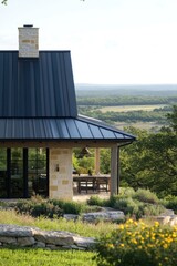 A contemporary stone house topped with a stylish metal roof commands a breathtaking view of the vibrant green countryside, showcasing nature’s beauty in broad daylight