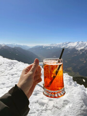 Relishing a Refreshing Drink Amidst the Stunning Mountains on a Bright, Sunny Afternoon