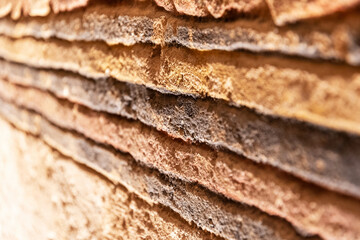 Textured surface with distinct layers, resembling stacked stone or sedimentary rock. Warm, earthy tones create a natural and organic feel