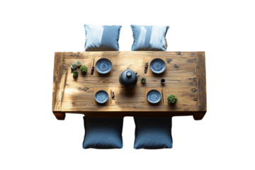 Wooden dining table with cushions, blue plates, plants, and chopsticks set for four people, isolated on a transparent background