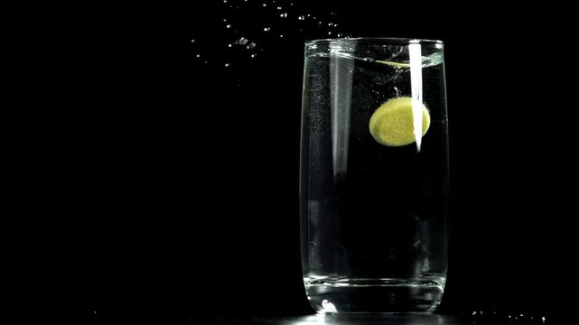 An aspirin tablet falls into a glass of water. Filmed on a high-speed camera at 1000 fps. High quality FullHD footage