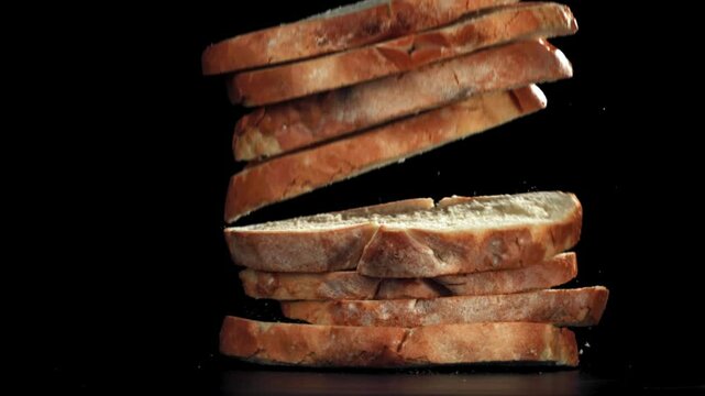 Pieces of bread falling on a black background. Filmed on a high-speed camera at 1000 fps. High quality FullHD footage
