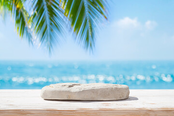 Beach stone as pedestal for product display on blurred tropical summer sea background