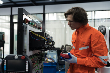 Electrician, Electrical engineer. Electrical circuit board on console panel. Electrician checking,...