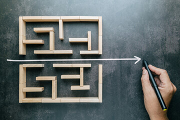 A hand that draws a straight line through a maze game with the shortest possible line, shorten the...