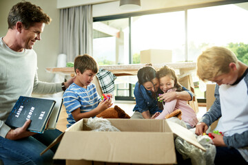 Hug, boxes and family packing in new home with sorting items for donation, charity or community. Cardboard, moving and parents helping children sort household supplies for relocation in house.