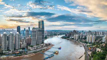 Panoramic view of the modern city skyline with river and bridge at sunset in Chongqing. Business...
