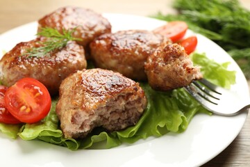 Delicious patties, tomato, dill and lettuce on table, closeup