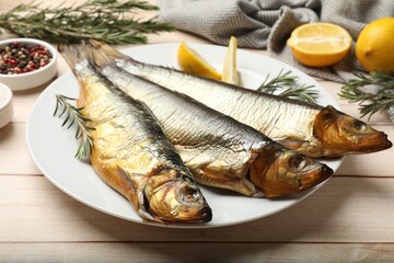 Smoked herrings and spices on wooden table, closeup