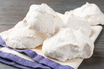 Delicious homemade meringue cookies on wooden table, closeup