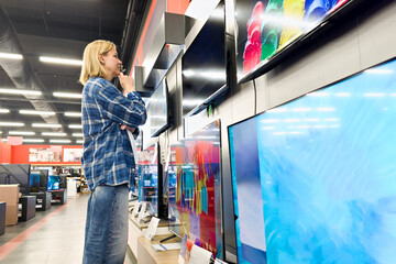 Woman buying TV in shop