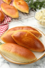Tasty baked patties on white marble table