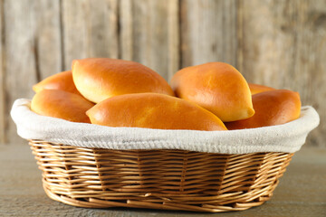 Tasty baked patties on wooden table, closeup