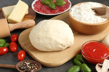 Making pizza. Different ingredients on gray textured table, closeup