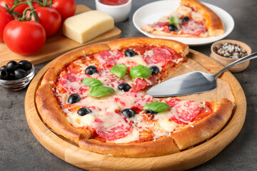 Tasty pizza and ingredients on grey table, closeup