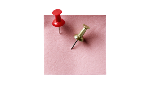 Stationery Essentials: A captivating shot of pushpins poised atop a piece of paper, these colorful stationery item stand out with their functionality and aesthetic charm.