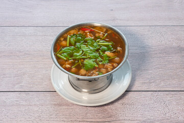 Spicy and sour pork leg soup