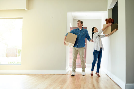 Boxes, moving and couple in new home for property ownership, relocation and investment. Cardboard, love and people with packages for buying real estate together in marriage for commitment at house.