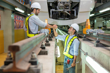 Engineers check the readiness of electric train tracks at the maintenance factory.