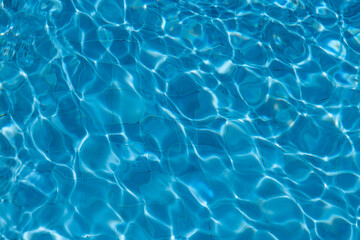 Blue Water Pool Surface with Sunlight Reflections