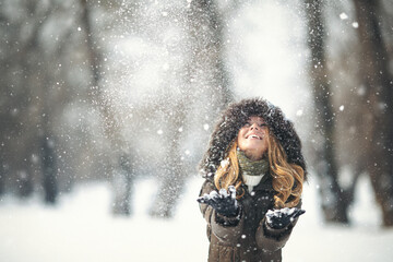 Young girl in the snow enjoing winter time