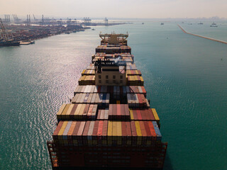 Large cargo ship transporting colorful containers across ocean