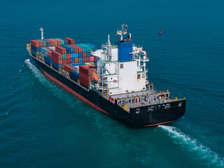Large cargo ship transporting colorful containers across ocean