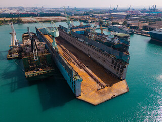 Shipyard with dry dock and large ship under construction