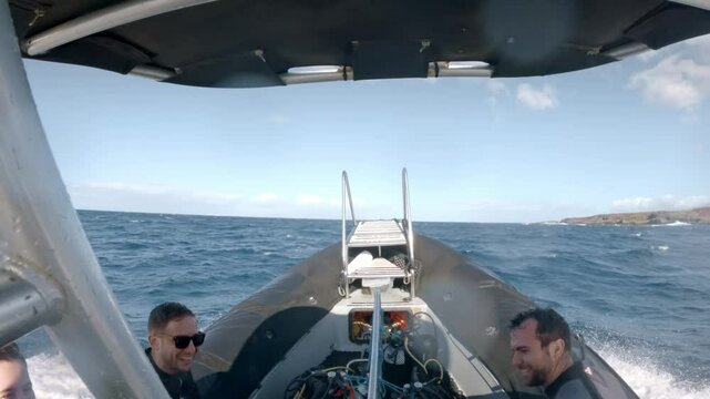 Divers navigating on a speedboat towards dive site