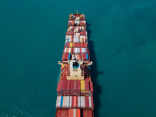 Large cargo ship transporting colorful containers across ocean