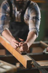 Young carpenter working in his workshop