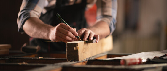 Young carpenter working in his workshop