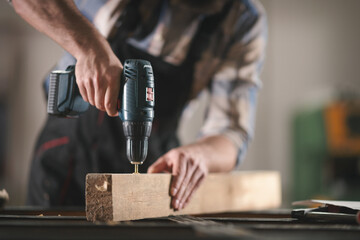 Young carpenter working in his workshop