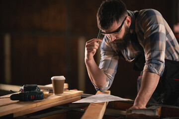 Young carpenter working in his workshop