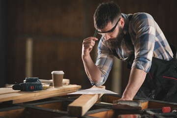 Young carpenter working in his workshop
