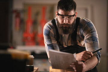 Young carpenter working in his workshop