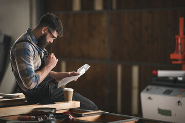Young carpenter working in his workshop