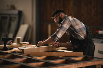Young carpenter working in his workshop