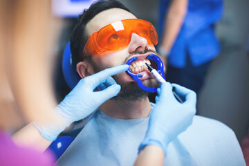 Young man at dentist. Shallow DOF. Developed from RAW; retouched with special care and attention;...
