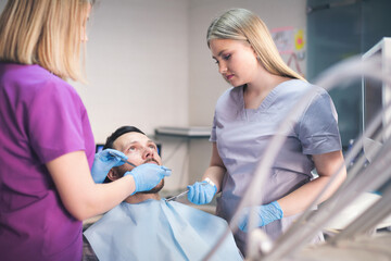 Young man at dentist. Shallow DOF. Developed from RAW; retouched with special care and attention;...