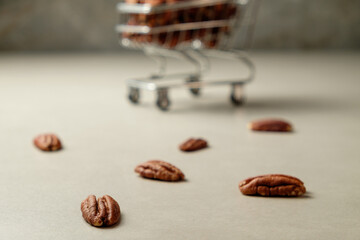 Delightful pecan nuts scattered near a shopping cart filled with more