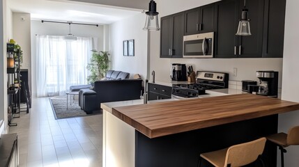 Open-concept living area with modern kitchen.  Spacious, light-filled apartment.  Dark cabinets, light countertops.  Comfortable seating area