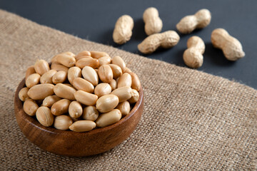 Bowl full of peeled and roasted shells peanuts,top view