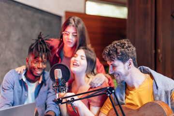 Group of diverse musicians creating music together in recording studio