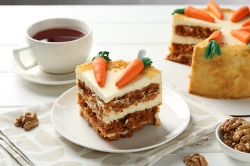 Delicious homemade carrot cake served on white wooden table