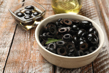Delicious marinated olive rings on wooden table, closeup