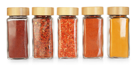 Many different aromatic spices in jars isolated on white